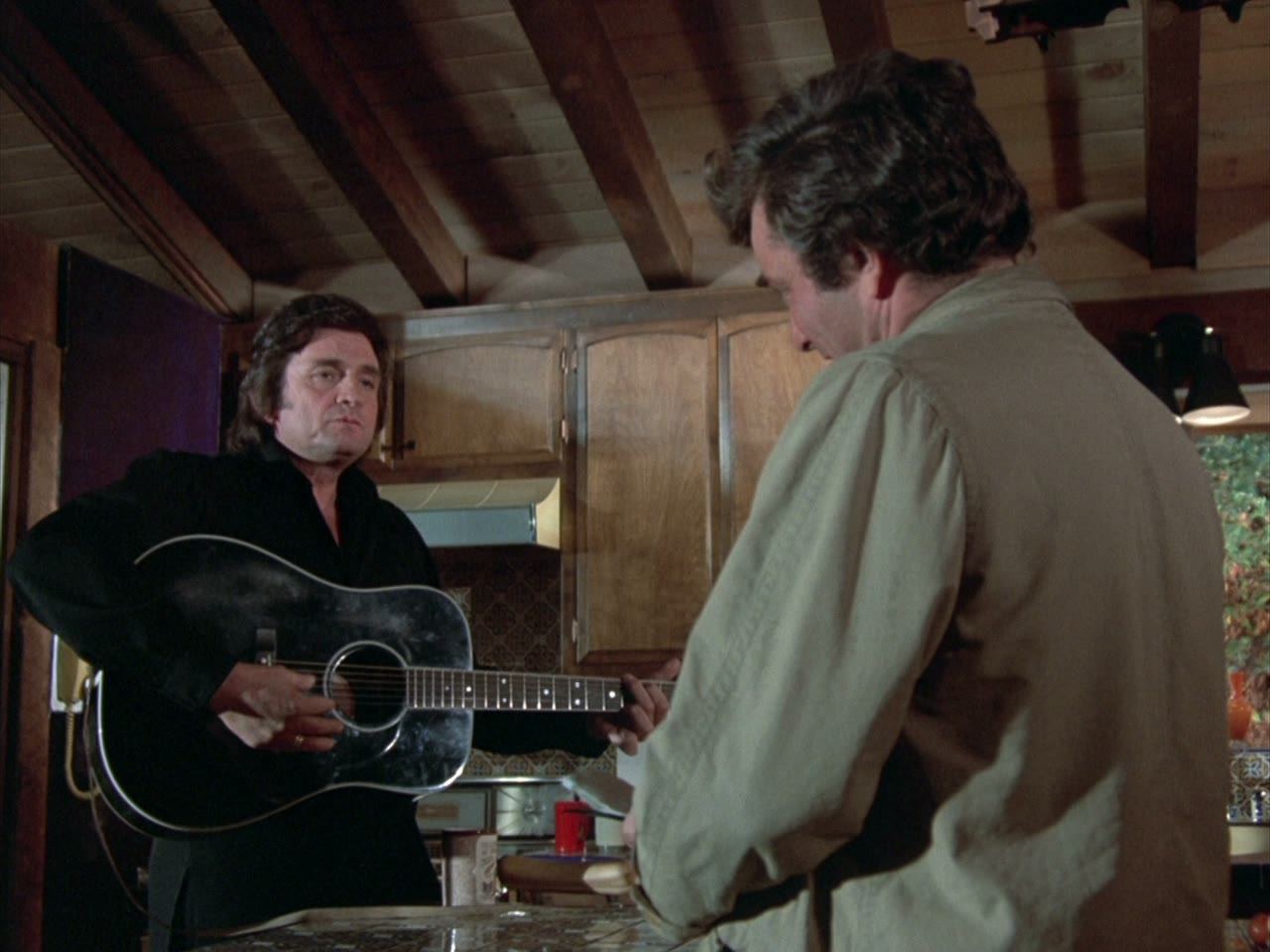 Brown picks up the guitar, and the conversation goes his way